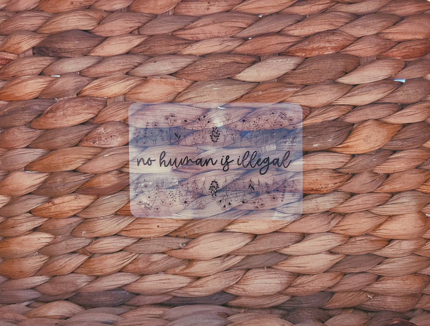 clear "no human is illegal" sticker  |  simple transparent floral sticker (CHIRLA collection)