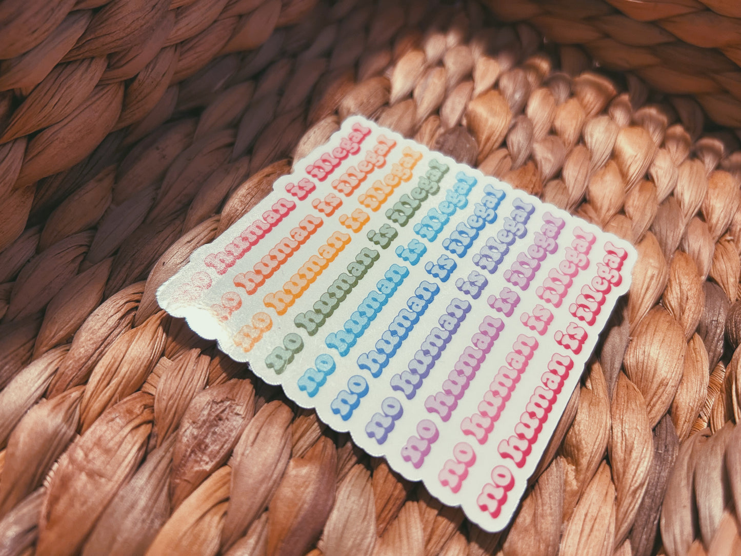 colorful "no human is illegal" sticker  |  holographic rainbow sticker (CHIRLA collection)
