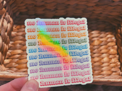 colorful "no human is illegal" sticker  |  holographic rainbow sticker (CHIRLA collection)