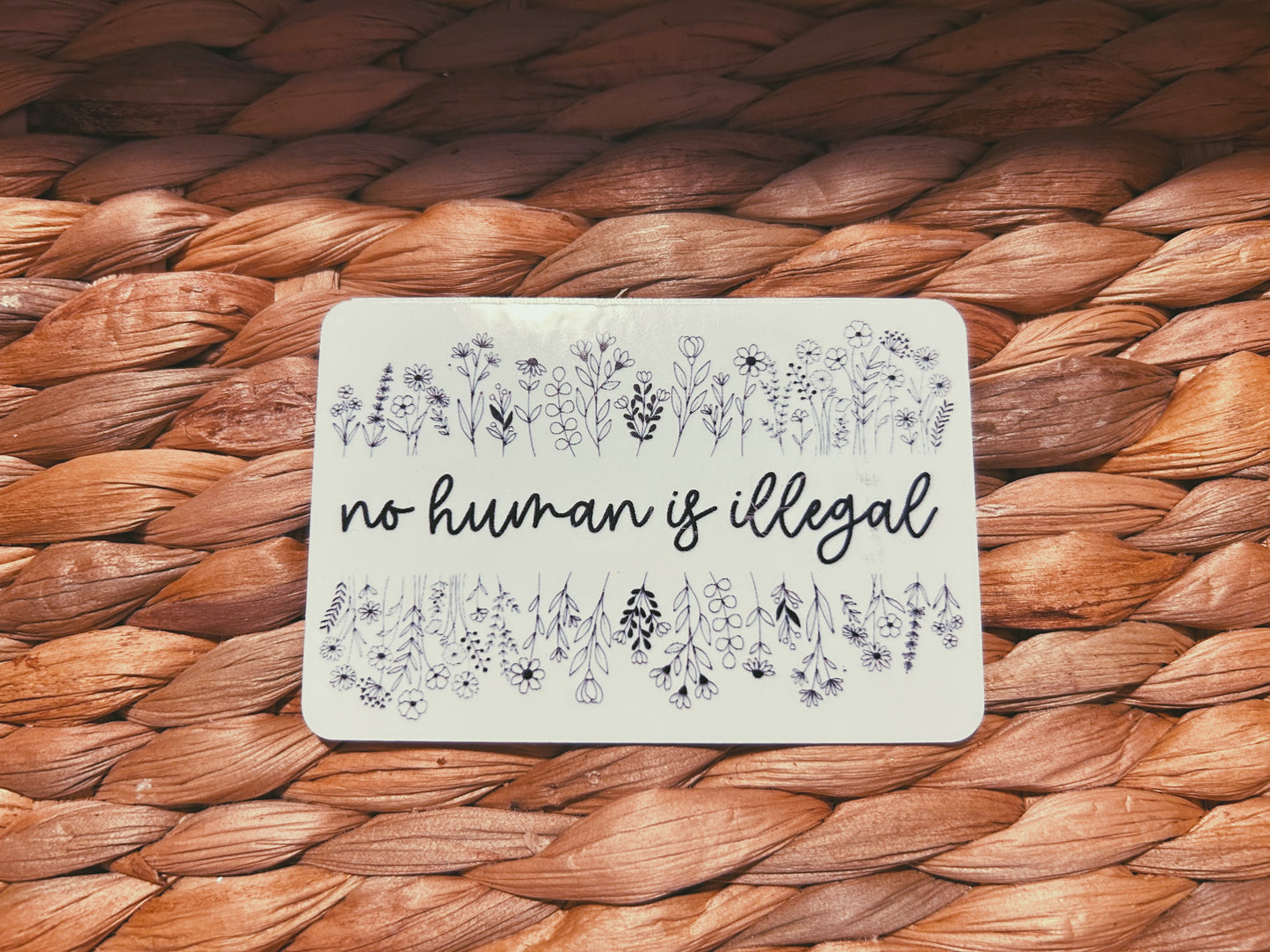 clear "no human is illegal" sticker  |  simple transparent floral sticker (CHIRLA collection)