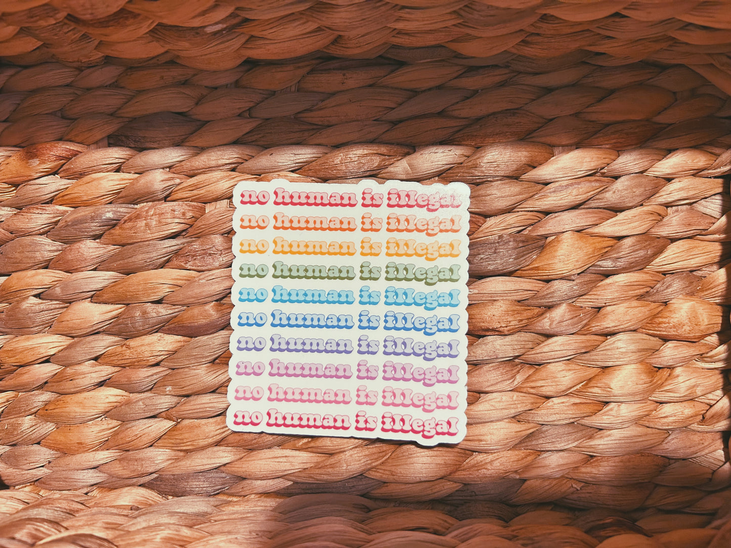 colorful "no human is illegal" sticker  |  holographic rainbow sticker (CHIRLA collection)